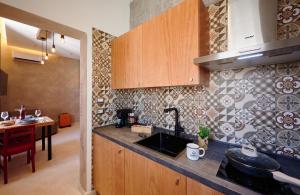a kitchen with a sink and a counter top at Mamaco Trani Homey in Trani
