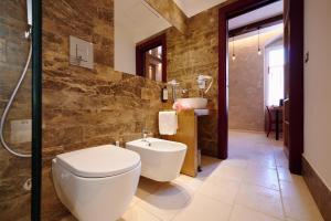 a bathroom with a toilet and a sink at Mamaco Trani Homey in Trani