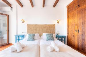 a bedroom with a large bed with two blue tables at Hotel Rural Almazara in Frigiliana