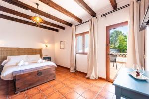 a bedroom with a bed and a large window at Hotel Rural Almazara in Frigiliana +54 photos