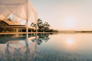 a pool of water with a tent on top of it at Casa Albarari Boutique Double Rooms with access to shared Infinity Pool in Sanxenxo