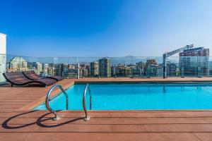 a swimming pool on the roof of a building at Nest Collection El Golf in Santiago
