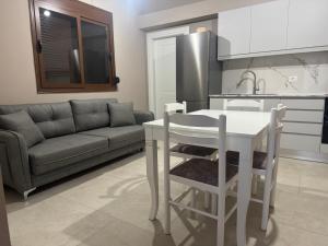 a kitchen with a couch and a table in a kitchen at KEAN Apartments in Vlorë +15 photos
