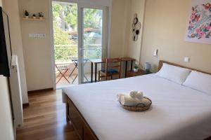 a bedroom with a bed with a teddy bear in a basket at Purerest Entire Private Villa in Athens