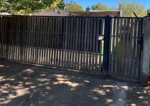 a wooden gate in front of a house at Departamento Favaloro in RSA