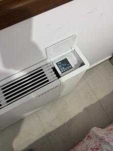 a cell phone sitting inside of a white drawer at KEAN Apartments in Vlorë