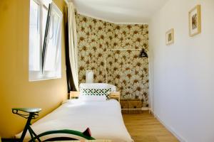 a small bedroom with a bed and a window at White and Light House in Costa da Caparica +20 photos
