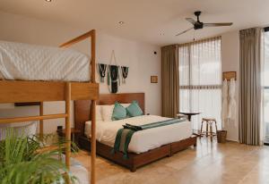 a bedroom with a bed and a bunk bed at Totem Beach Club - Celestun in Celestún +100 photos