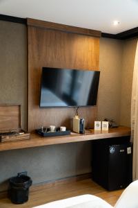 a flat screen tv on a wall in a hotel room at Ayres de Calafate in El Calafate