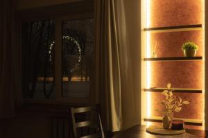 a room with a table and a window with a plant at Park-View Studio Apartment with Free Parking - 10 min to Old Town in Riga +31 photos