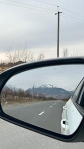 a rear view mirror of a car on the road at Алия in Tossor