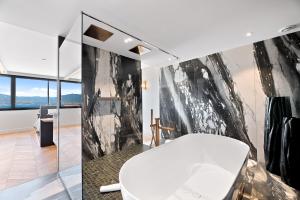 a bathroom with a black and white wall at Hotel San Carlu Citadelle Ajaccio in Ajaccio