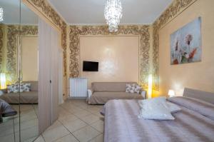 a bedroom with a bed and a couch at Relax House in Squinzano