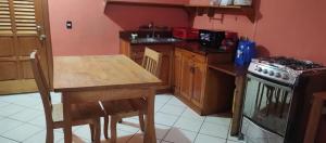 a kitchen with a wooden table and a stove at Casas de Qlí in Santiago Atitlán +16 photos