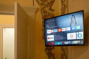 a flat screen tv hanging on a wall at Relax House in Squinzano