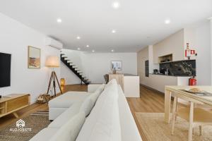 a living room with a white couch and a table at Atlantic Apartments in Santa Cruz