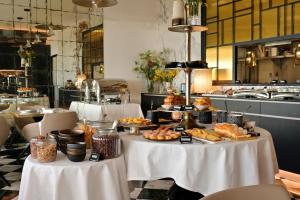 a buffet of food on two tables in a restaurant at Hotel San Carlu Citadelle Ajaccio in Ajaccio