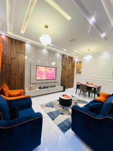 a living room with two blue couches and a table at Best place appartement in Cotonou