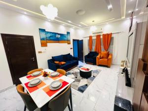 a living room with a table and a couch at Best place appartement in Cotonou