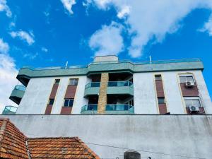 a tall building with windows on top of it at Apto Rio grande com varanda e 160mt de terraço in Rio Grande
