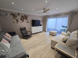 a living room with a couch and a tv at Grace's Spacious Home in Ely in Ely
