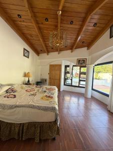 a bedroom with a large bed and a wooden ceiling at Hotel Minnesota y Centro de Eventos Molina in San Lucas Tolimán