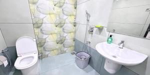 a bathroom with a toilet and a sink at Hestia Homestay- 2 Bedroom Retreat Aymanam in Kottayam