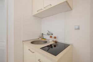 a bathroom with a sink and a mirror at Sea Point Apartments Igalo in Igalo +46 photos