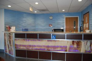 a waiting area in a hospital with a blue wall at Pleasant Hill Inn in Pleasant Hill