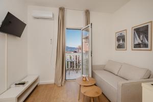 a living room with a couch and a table at Sea Point Apartments Igalo in Igalo