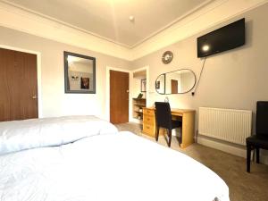 a hotel room with two beds and a desk at Meze hotel in Perth