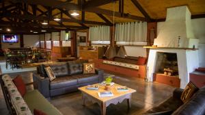 a large living room with couches and a fireplace at Hotel Fazenda Bela Vista in Dourado
