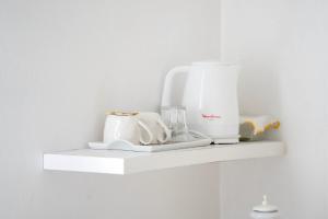 a white shelf with a coffee maker on it at Casa Morais in Odeceixe