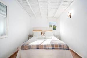 a bedroom with a bed with two shoes on it at Casa Morais in Odeceixe