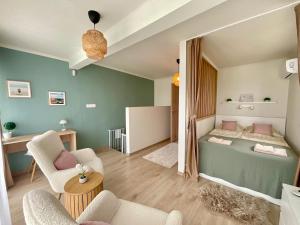 a small room with a bed and chairs in it at Sunny Private Beach in Balatonlelle