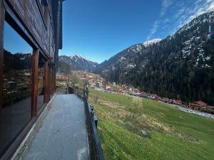 a balcony of a house with a view of a mountain at Ayder Villa Bravo in Çamlıhemşin