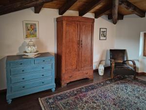 a room with a dresser and a cabinet and a chair at Le Ortensie Lago di Garda in Monzambano