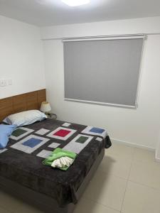 a bedroom with a bed with a large window at Paraiso dos coqueiros - Guarajuba - Bahia -Linha verde in Camaçari +15 photos