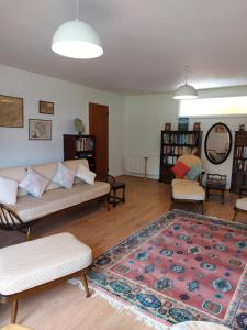 a living room with two couches and a rug at Gidansu in Penrith