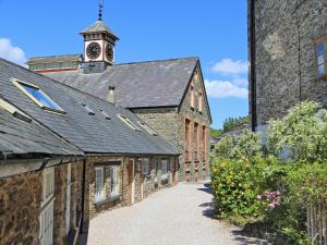 an old building with a clock tower on top of it at Tuckenhay, 3 Salle Cottage- Fcs in Ashsprington