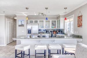 a kitchen with a large counter with stools at Fun Times At Nye Beach in Newport