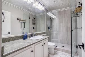 a bathroom with a sink and a toilet and a shower at Fun Times At Nye Beach in Newport +34 photos
