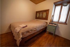 a small bedroom with a bed and a table at Flora Birgi Taş Konak in Odemis
