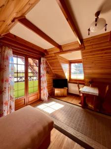 a bedroom with wooden walls and a bed in a room at GAMP Paweł Sawicki in Kleszczele