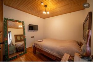 a bedroom with a bed and a mirror at Flora Birgi Taş Konak in Odemis