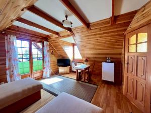 a room with a bed and a television in a room at GAMP Paweł Sawicki in Kleszczele