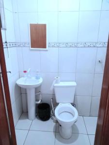 a bathroom with a toilet and a sink at Ambiente familiar em Poços de caldas in Poços de Caldas +22 photos