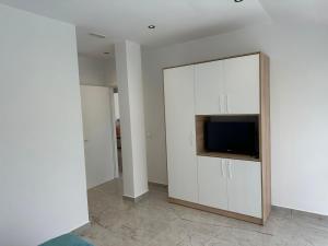 a living room with a tv in a white wall at guest house Qyteza in Shkodër