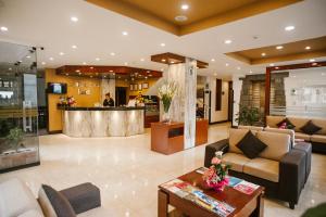 a lobby with couches and a bar in a building at Royal Inn Cusco Hotel in Cusco