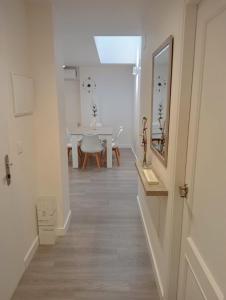 a hallway with a table and a dining room at Apartamentos Antuña in Cangas de Onís